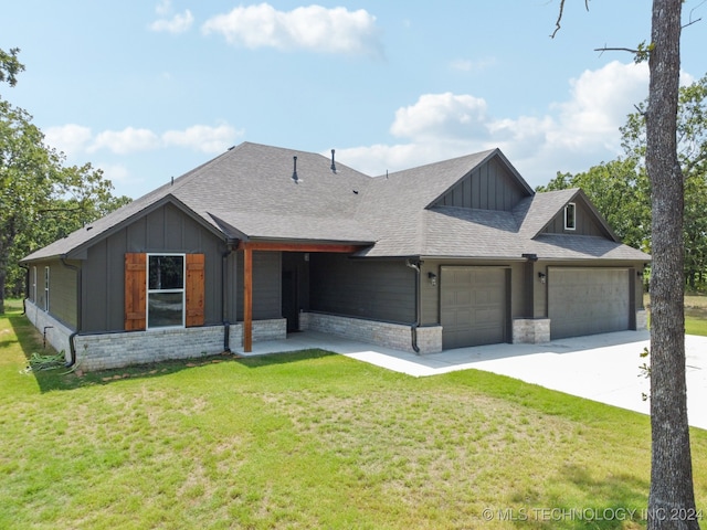 view of front of house featuring a garage and a front lawn