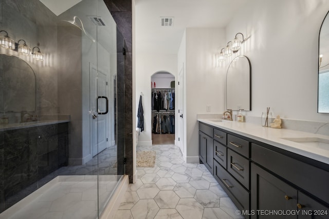 bathroom with vanity, tile patterned floors, and tiled shower