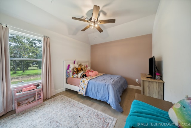 bedroom with lofted ceiling, wood-type flooring, and ceiling fan