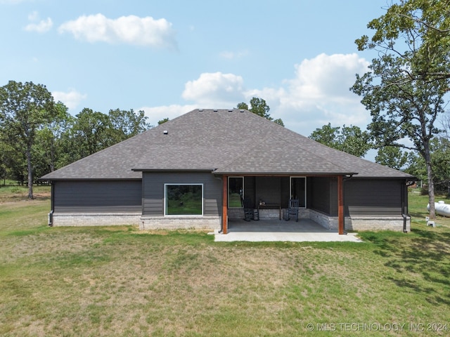 back of property featuring a yard and a patio area