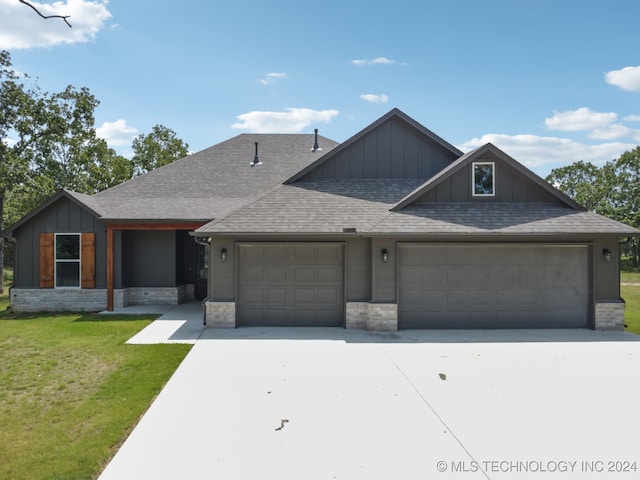 view of front facade with a front yard and a garage