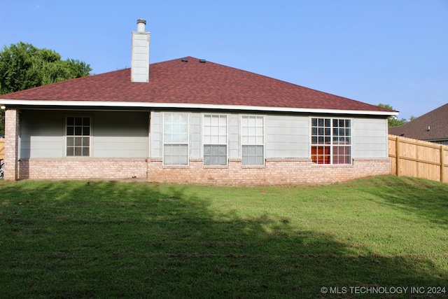 back of house with a lawn