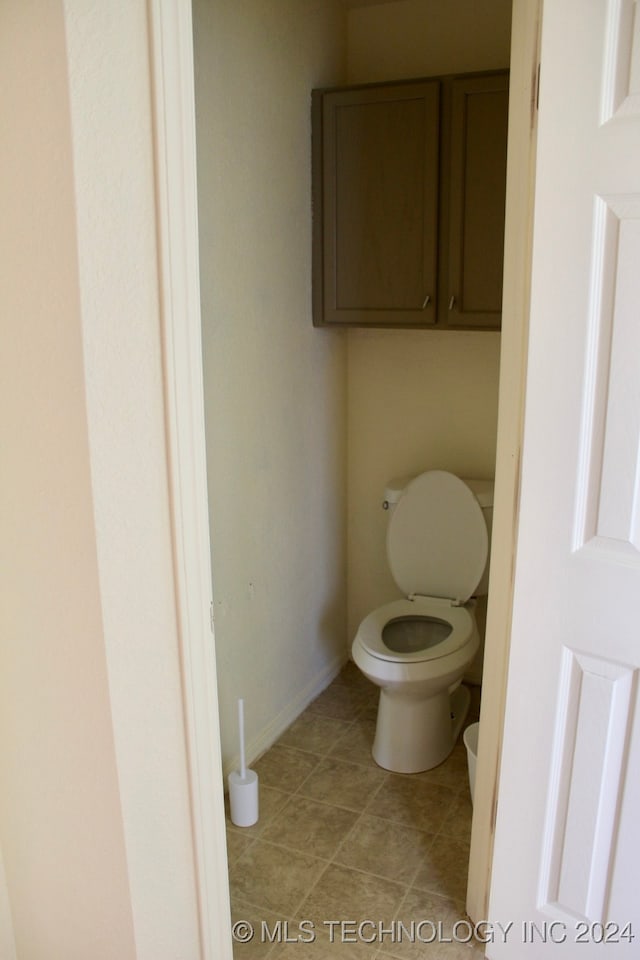 bathroom with tile patterned flooring and toilet