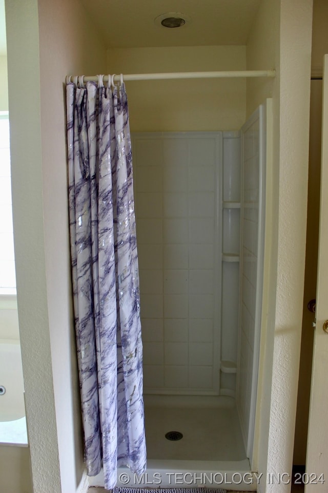 bathroom featuring walk in shower