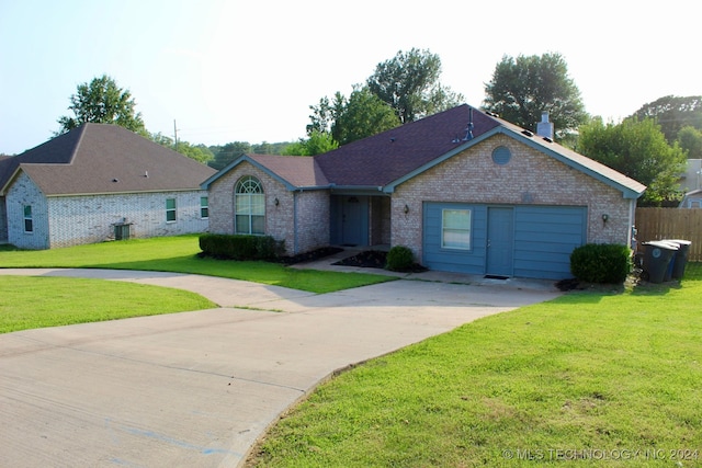 single story home featuring a garage and a front yard