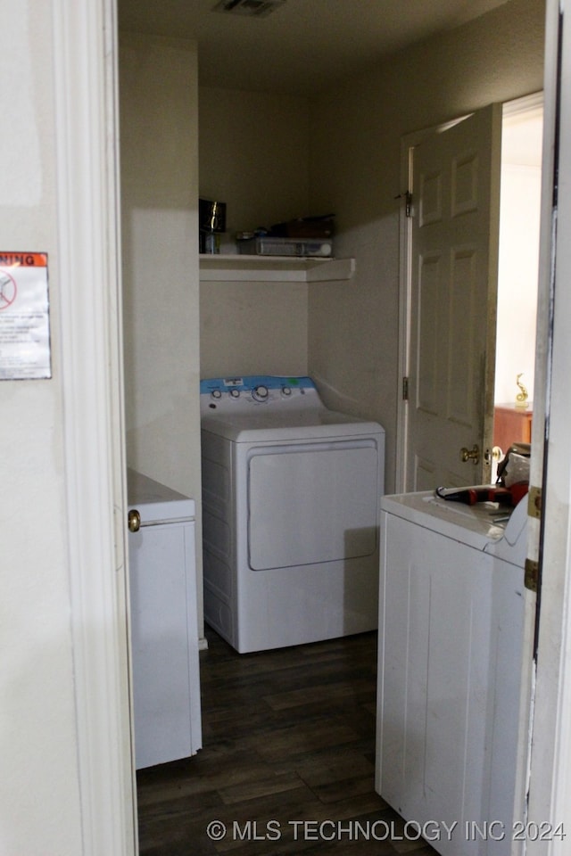 laundry area featuring dark wood-type flooring and washer and dryer