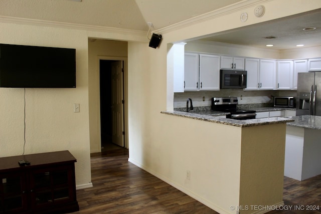 kitchen with appliances with stainless steel finishes, white cabinets, kitchen peninsula, light stone countertops, and dark wood-type flooring