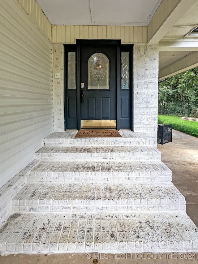 view of exterior entry featuring a porch