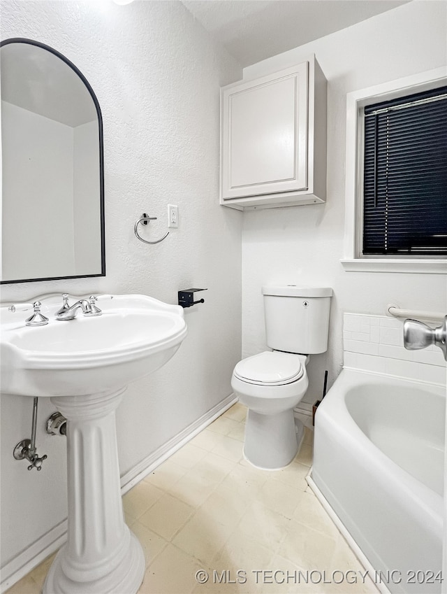 bathroom with toilet, tile patterned flooring, and a bathtub