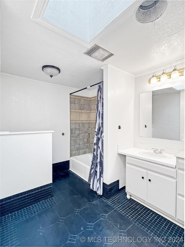 bathroom featuring shower / tub combo with curtain, vanity, tile patterned floors, and a textured ceiling