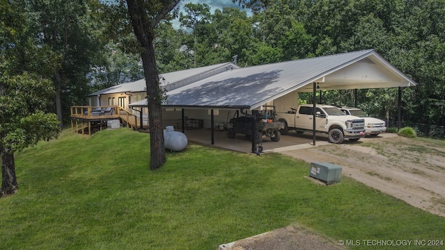 exterior space featuring a front lawn and a wooden deck