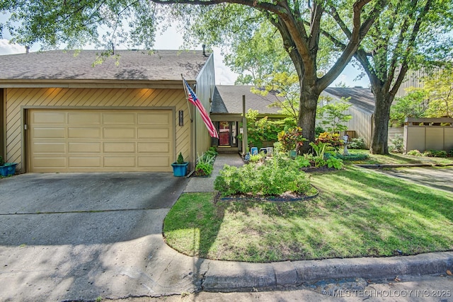 mid-century modern home with concrete driveway, a garage, a front yard, and a shingled roof