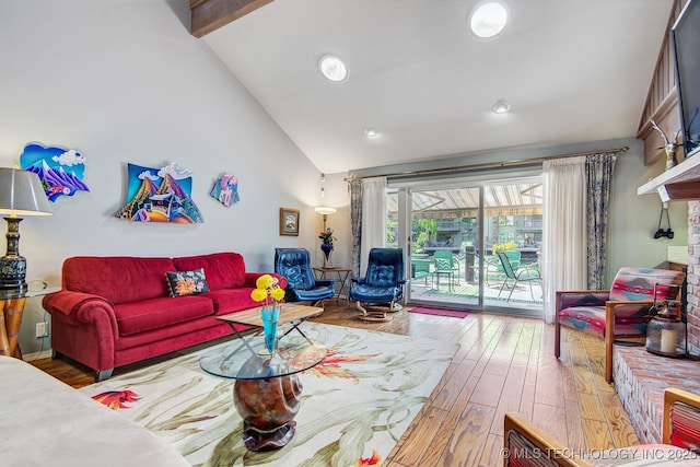 living room featuring beam ceiling, high vaulted ceiling, and wood finished floors