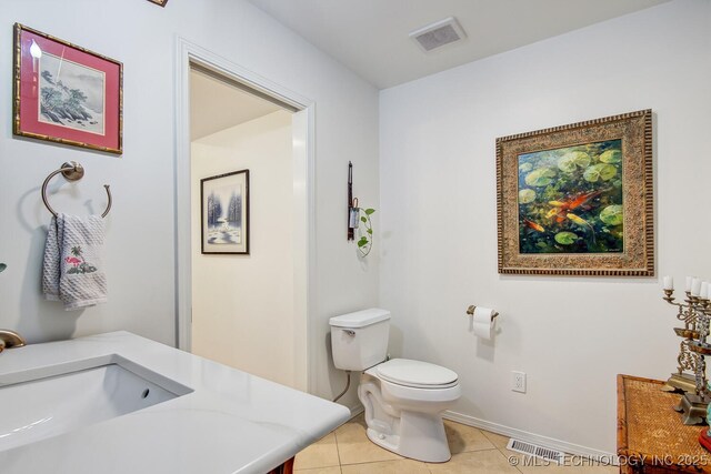 bathroom with tile patterned flooring, sink, and toilet