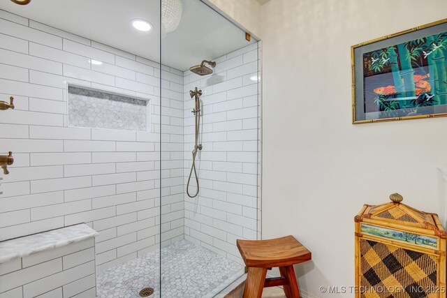 bathroom with a tile shower