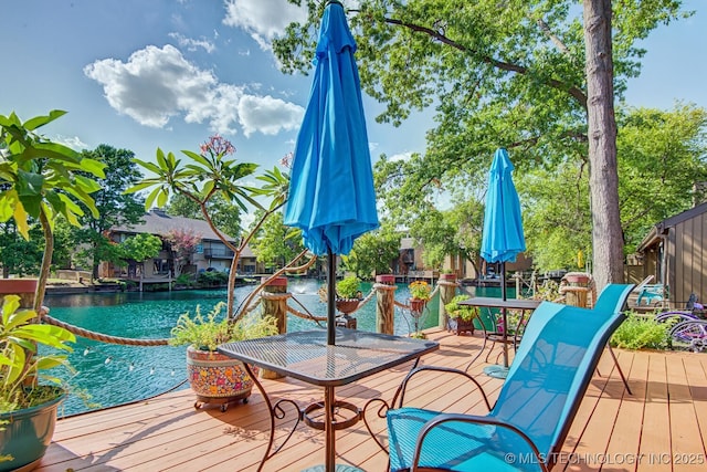 wooden deck featuring a water view