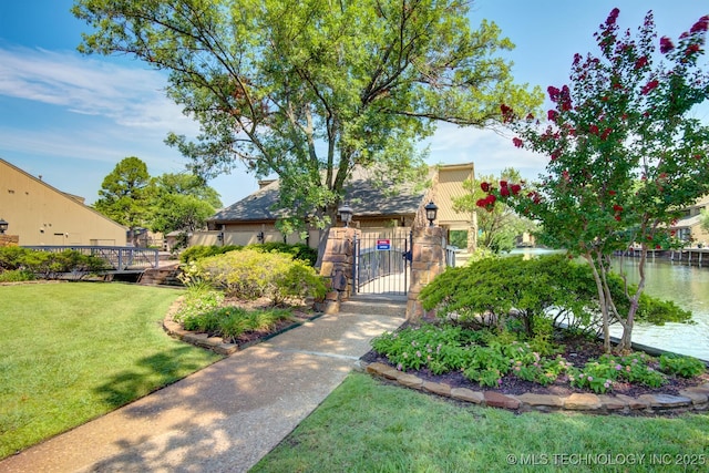 view of front of house featuring a water view and a front lawn