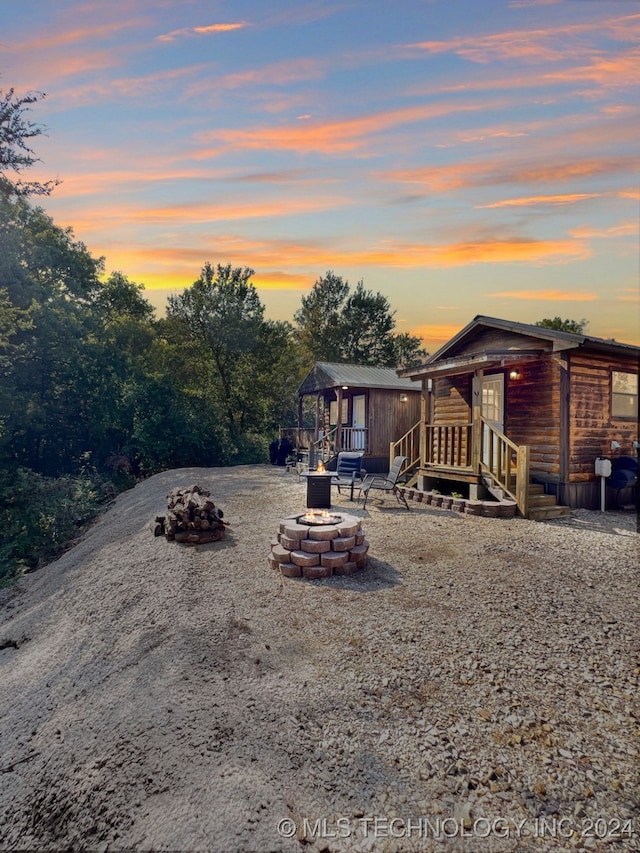 yard at dusk with a fire pit