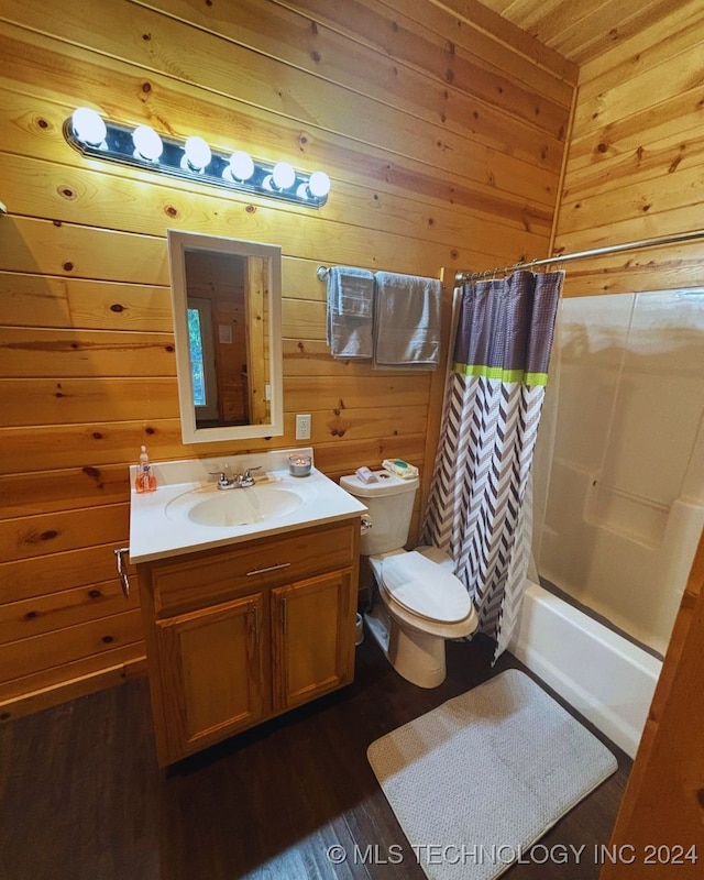 full bathroom with wood-type flooring, vanity, wood walls, shower / tub combo, and toilet