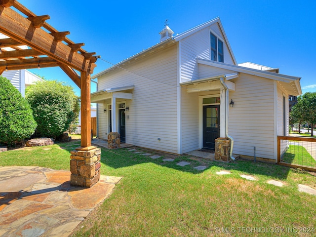 back of house with a yard, a patio area, and a pergola