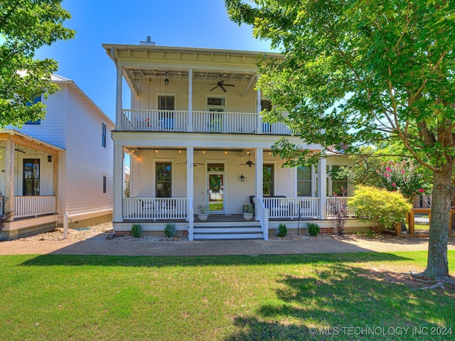 view of front of home featuring ceiling fan, a front yard, a porch, and a balcony