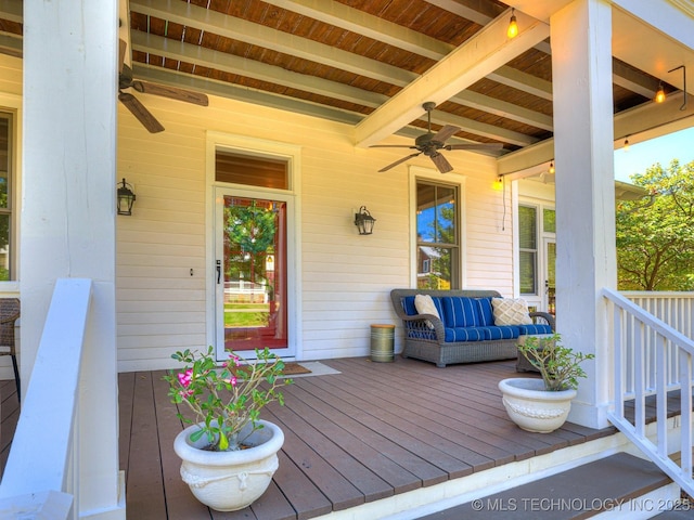 deck with an outdoor living space and a ceiling fan