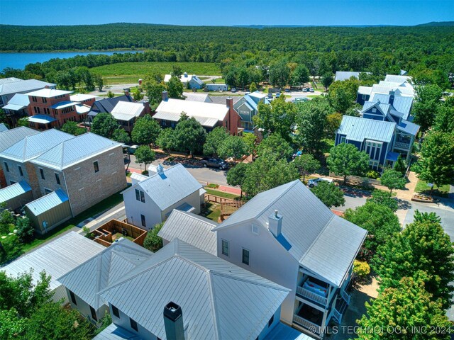 drone / aerial view featuring a residential view and a view of trees