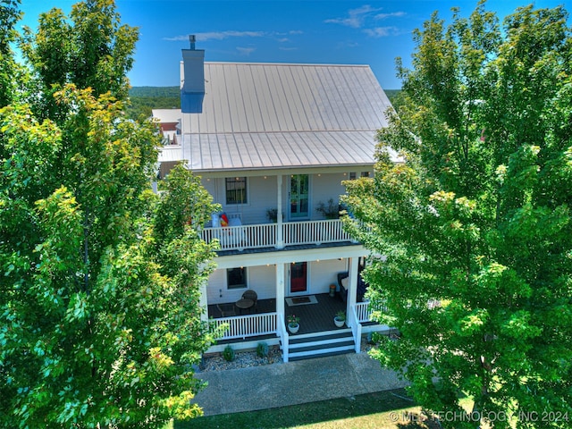 rear view of property with a porch