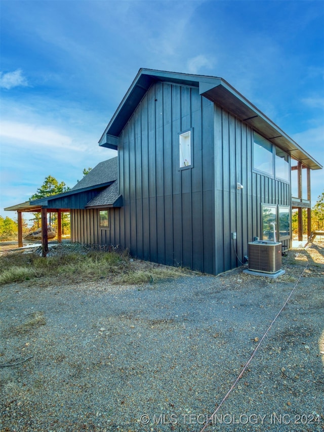 view of side of property with central air condition unit