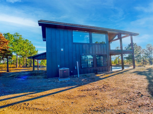 rear view of property with central AC unit