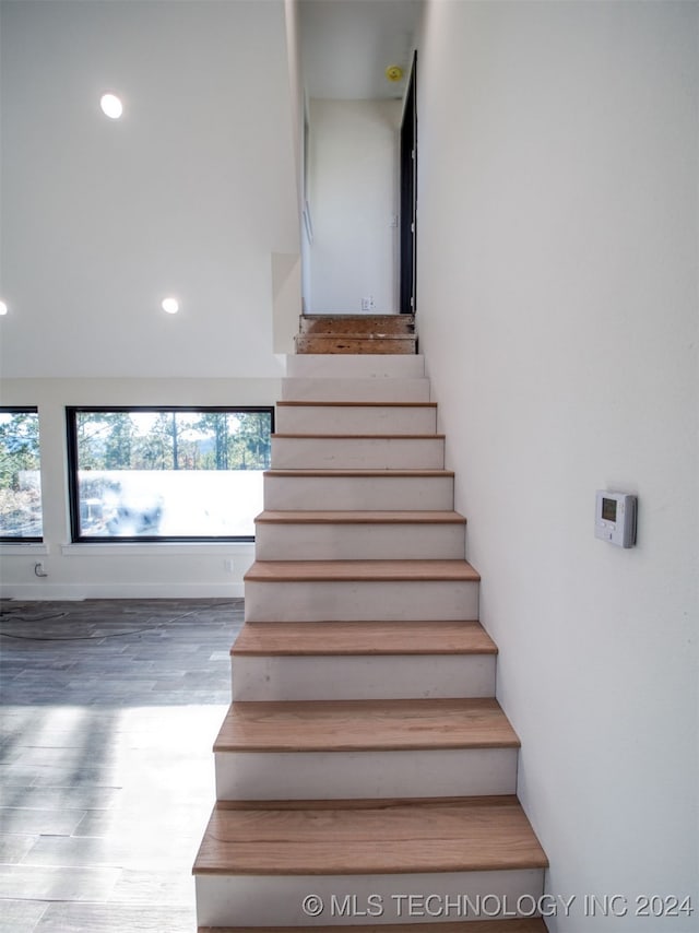 stairs featuring hardwood / wood-style flooring