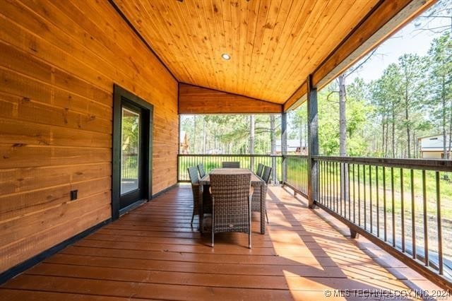 sunroom with lofted ceiling and wood ceiling