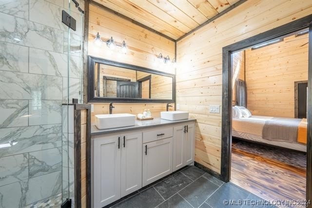 bathroom with wood-type flooring, double sink vanity, wooden ceiling, wooden walls, and an enclosed shower