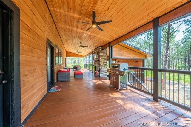 wooden terrace featuring ceiling fan