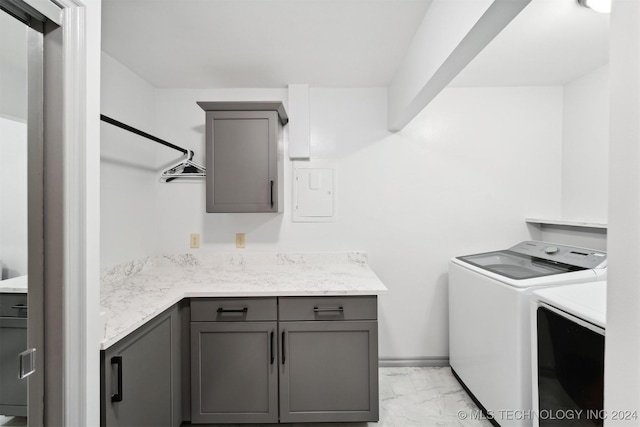 washroom featuring cabinets, independent washer and dryer, and electric panel