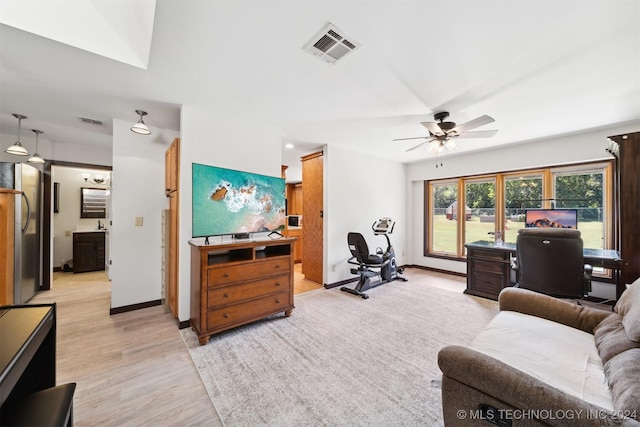 living room with ceiling fan and light hardwood / wood-style flooring