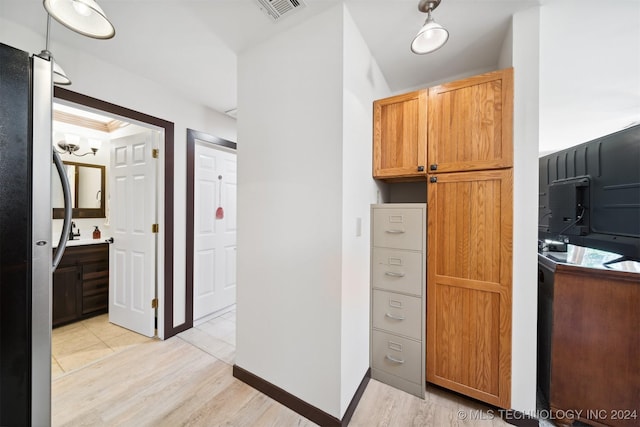 kitchen with stainless steel refrigerator and light wood-type flooring