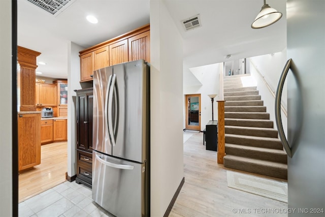 kitchen featuring stainless steel refrigerator and light wood-type flooring