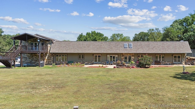 back of property with a patio and a lawn