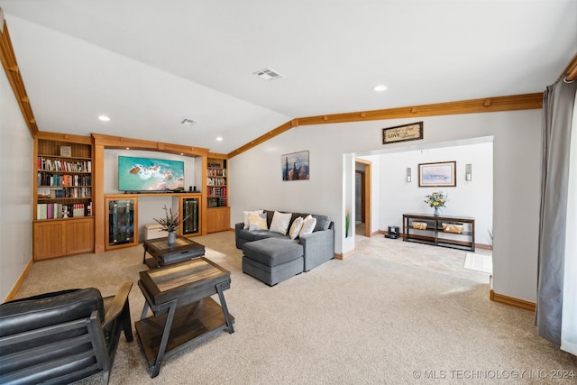 living room featuring vaulted ceiling, carpet flooring, beverage cooler, and built in shelves