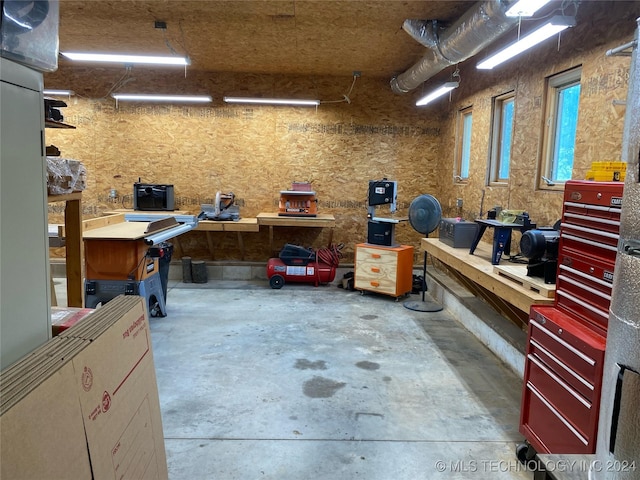 misc room with a workshop area and concrete floors