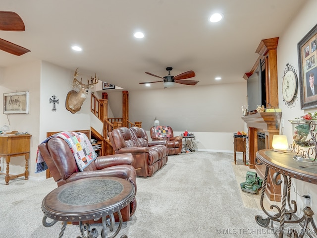 carpeted living room featuring ceiling fan