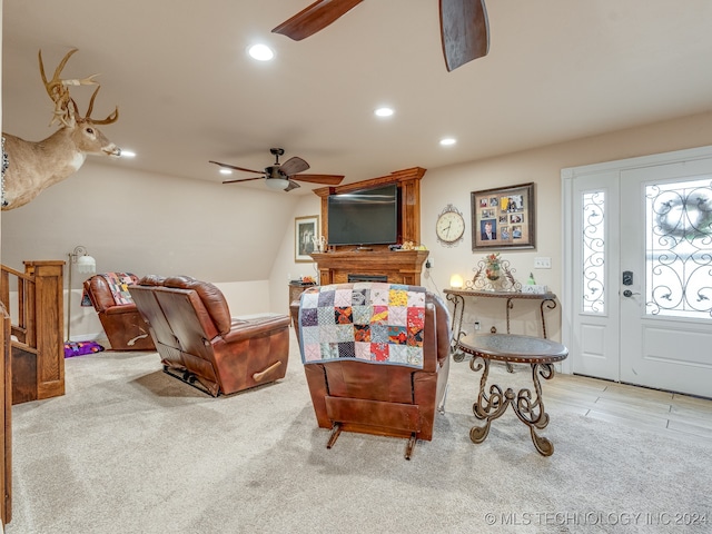 living room with light colored carpet and ceiling fan