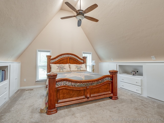 carpeted bedroom with a textured ceiling, ceiling fan, and vaulted ceiling