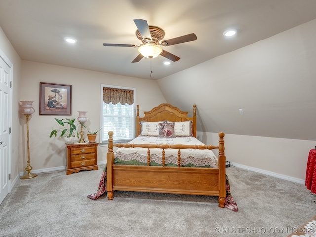 bedroom with light carpet, vaulted ceiling, and ceiling fan