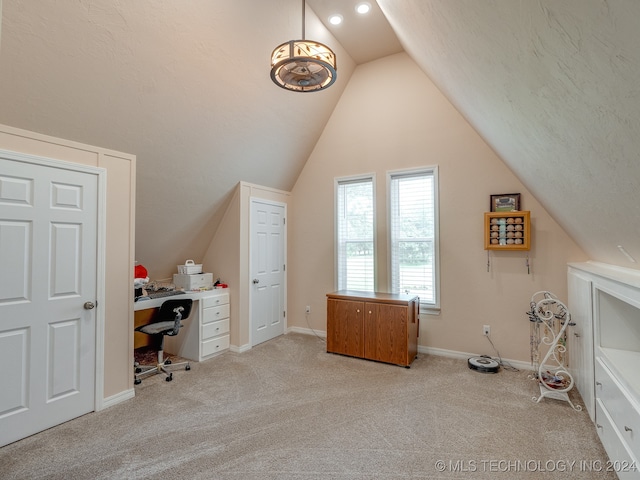 carpeted office featuring vaulted ceiling and a textured ceiling