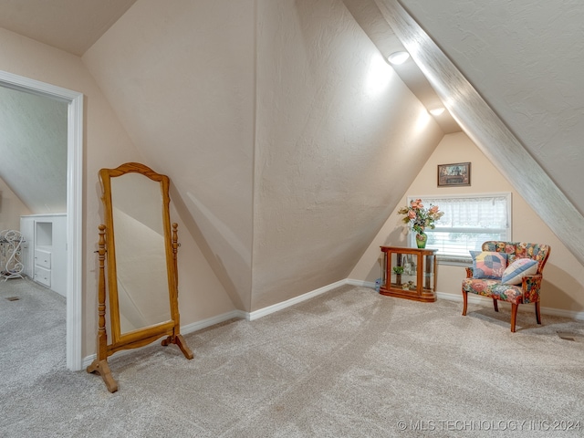 living area featuring carpet floors and lofted ceiling