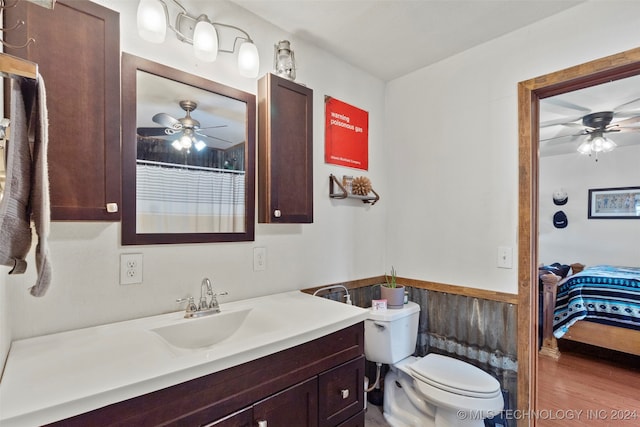 bathroom with ceiling fan, toilet, vanity, and hardwood / wood-style flooring