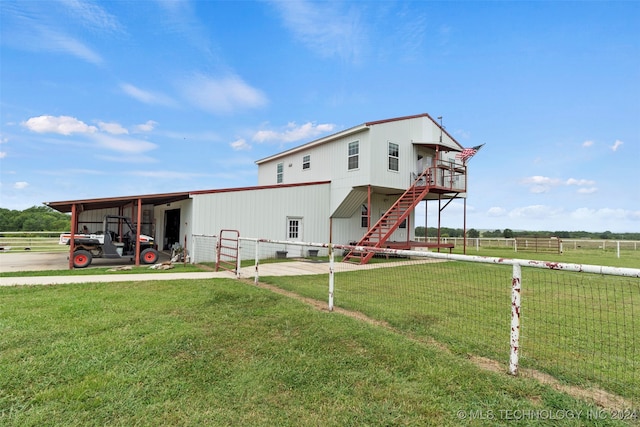 back of house featuring a carport and a lawn