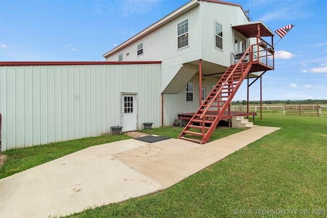 back of property featuring a lawn